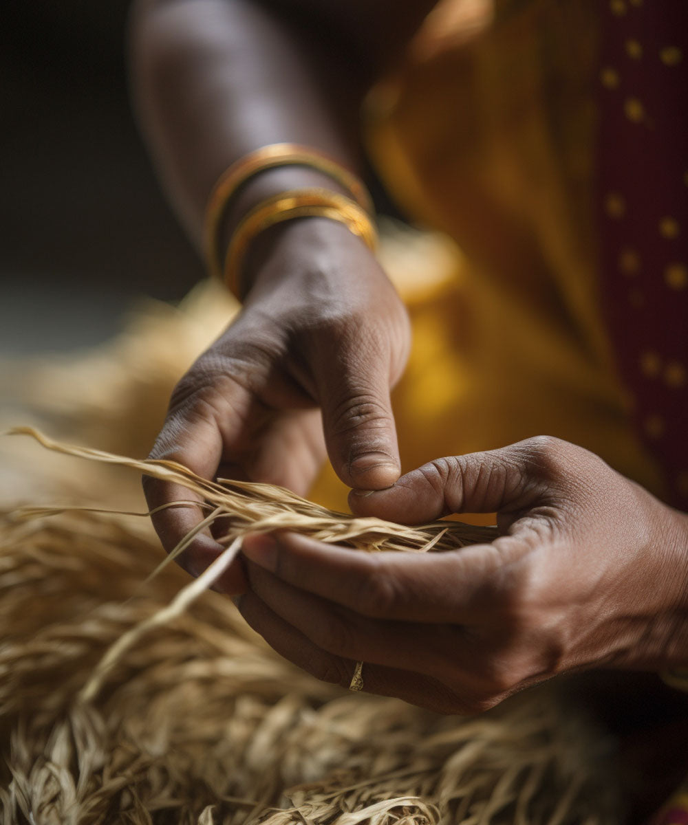 Close up of a Bengali woman's hands working with strands of jute