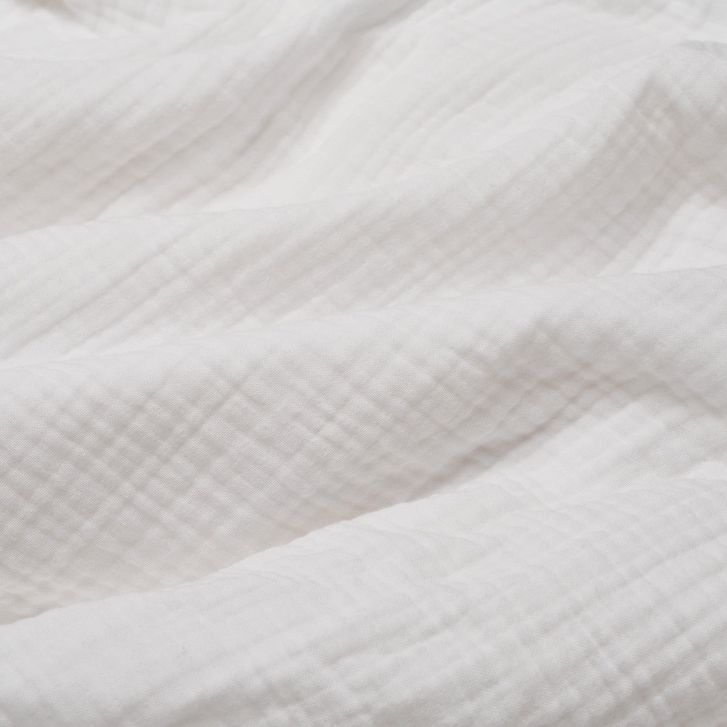 Close up of white muslin duvet material 