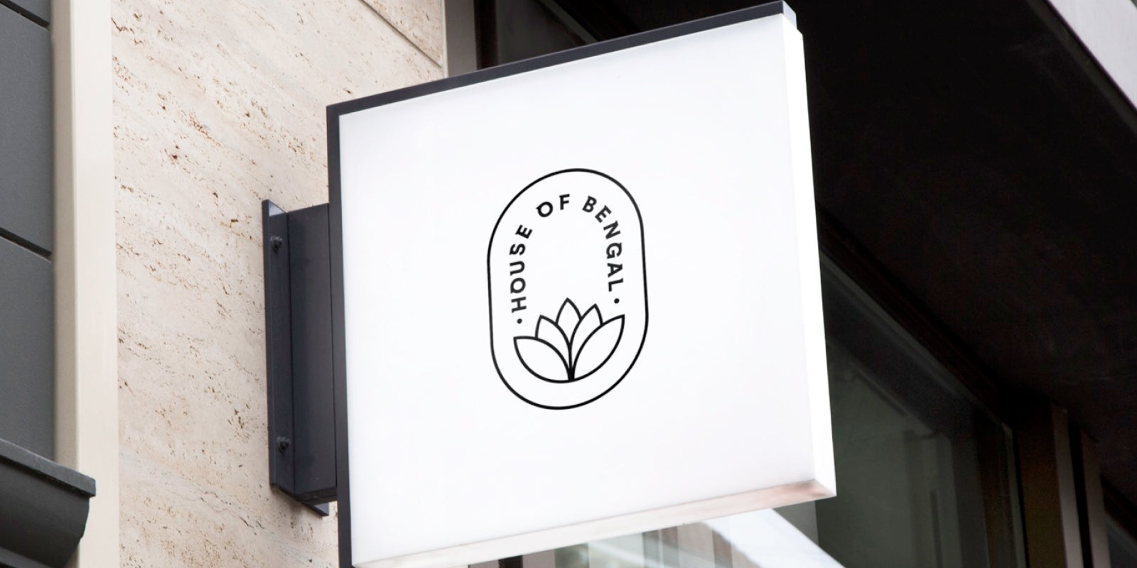Storefront signage for House of Bengal, logo on a white sign board
